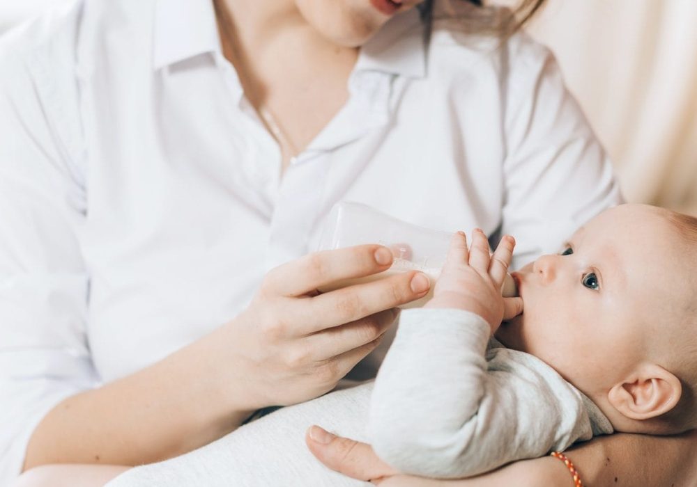 caring-mother-bottle-feeds-her-newborn-baby-caring-for-the-health-of-children-artificial-feeding-e1634200002827.jpg